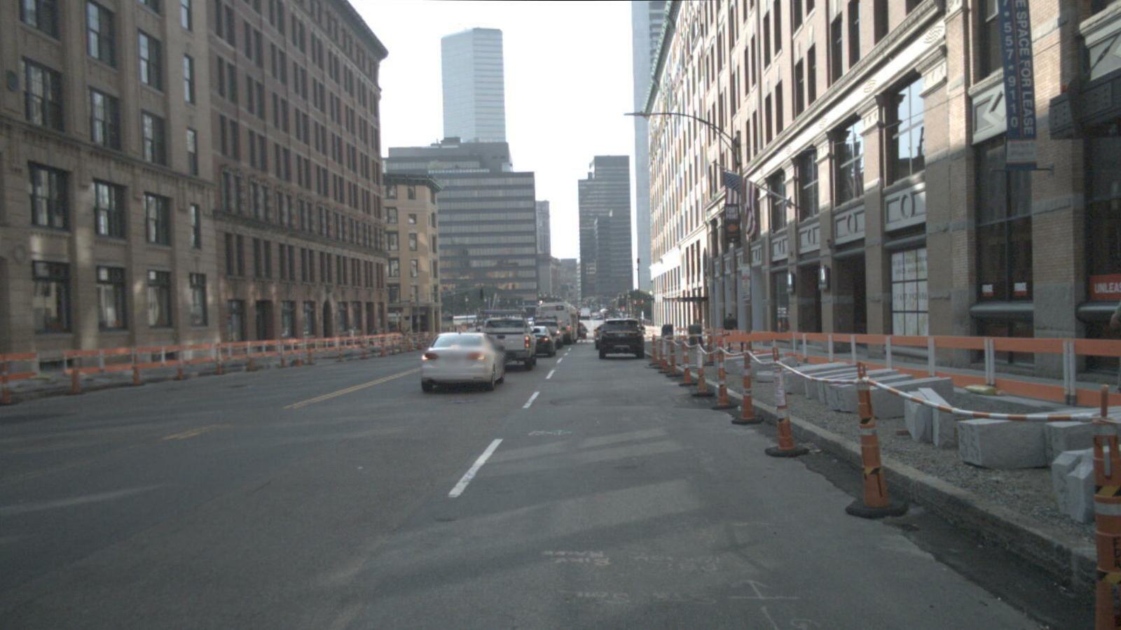 City street scene with bus and construction barriers